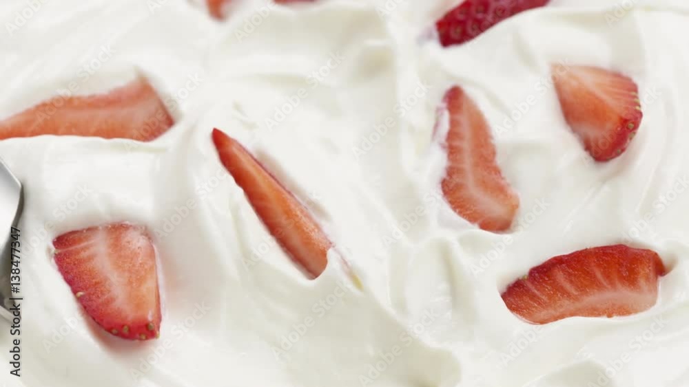 Slow motion of eating strawberries with cream with spoon, 180fps prores footage Slow motion of eating strawberries with cream with spoon, 180fps prores footage
