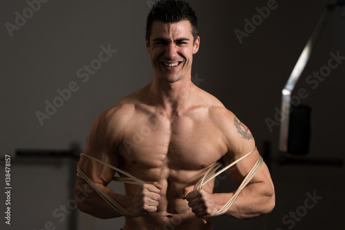 Bodybuilder Wrapt Up With Cable photo