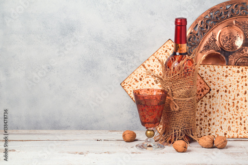 Passover holiday concept with wine and matzoh over rustic background with copy space
