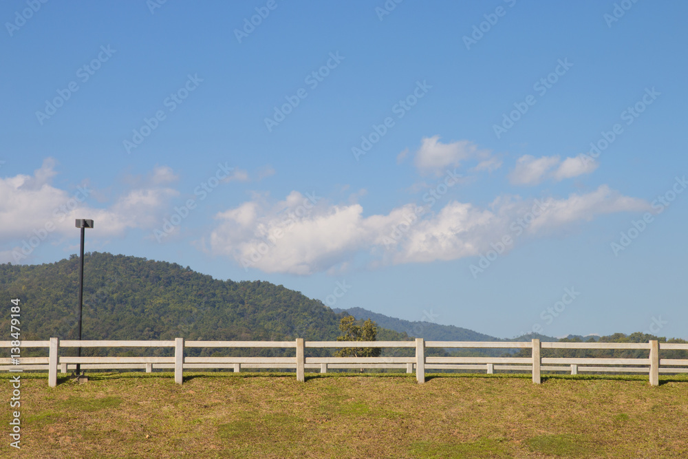 wood fence with grass and blue sky wood fence with grass and blue sky