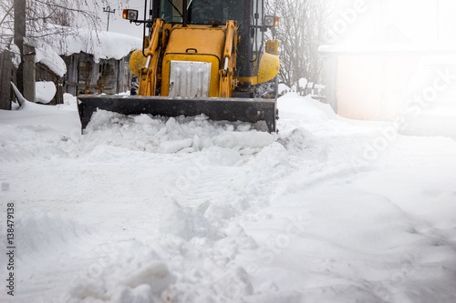 Snow clearing. Tractor clears the road after snowfall