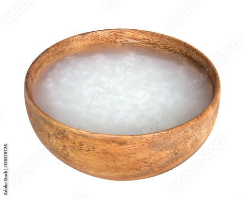Mush or boiled rice asian style in wood bowl isolated on white background, clipping path included