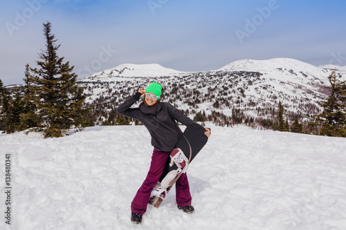 Portrait of young smiling woman with snowboard