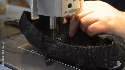Dressmaker sewing pieces of clothing together