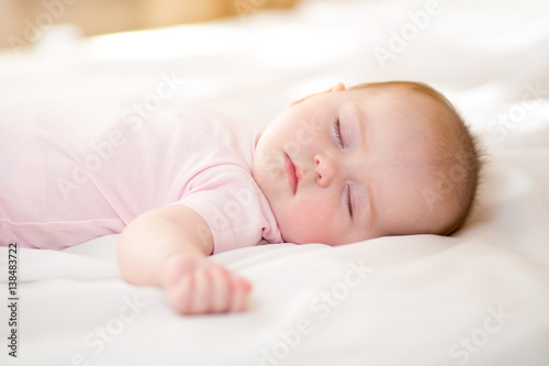 sweet baby infant sleeping on bed