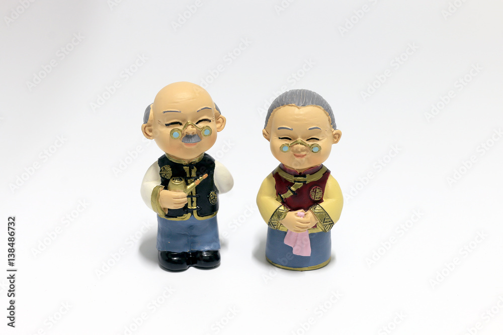 Two dolls which made like grand mom & grand dad in chinese uniform style standing on white background. Two dolls which made like grand mom & grand dad in chinese uniform style standing on white background.