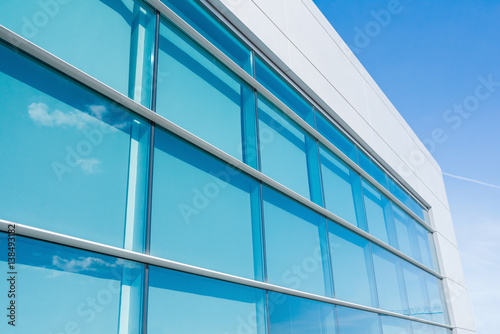 Detail of a modern glass building. Wall with glass exterior.