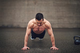 Front view of sportive shirtless doing push-ups