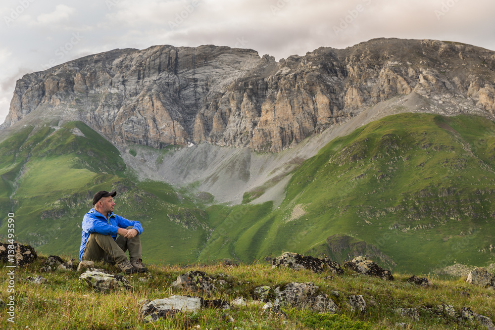 Hiker relaxing in Caucasian rocky mountains