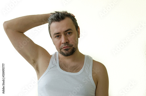 Portrait of a man in a white T-shirt, straightens hair