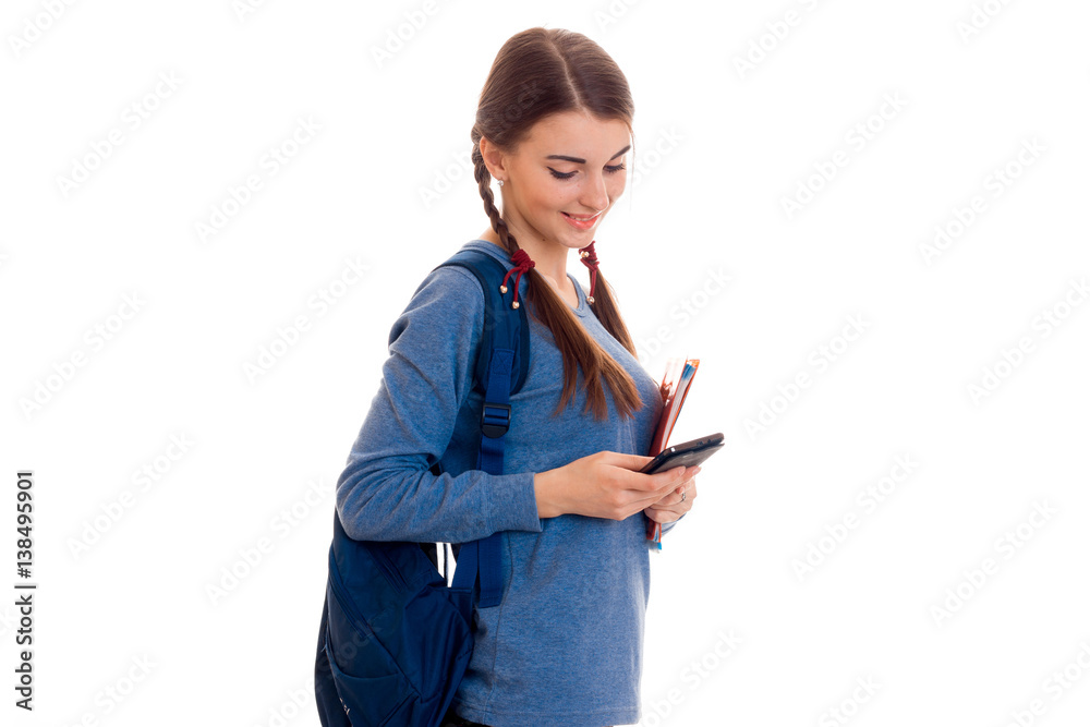 a teenage girl in the blue shirt is worth with a portfolio on the shoulders a teenage girl in the blue shirt is worth with a portfolio on the shoulders