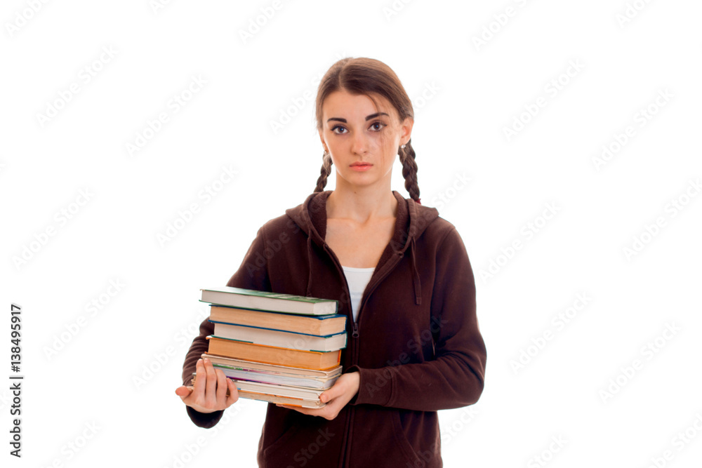 young girl with pigtails keeps the book in their hands and looking directly young girl with pigtails keeps the book in their hands and looking directly