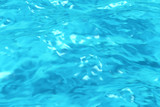 Blue water in swimming pool background closeup