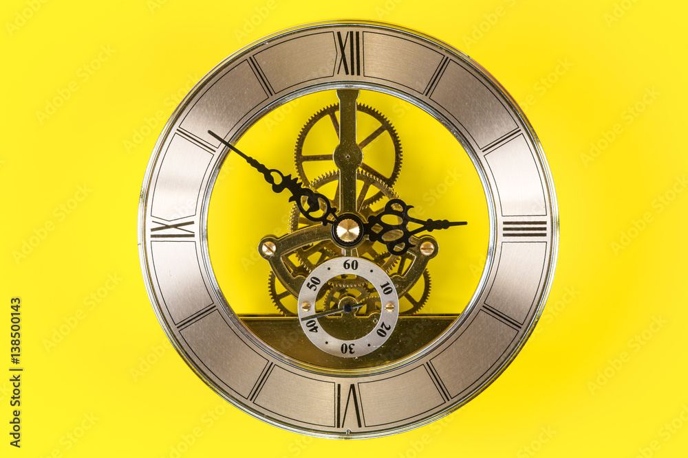 Fototapeta premium Vintage bronze clock isolated on a yellow background