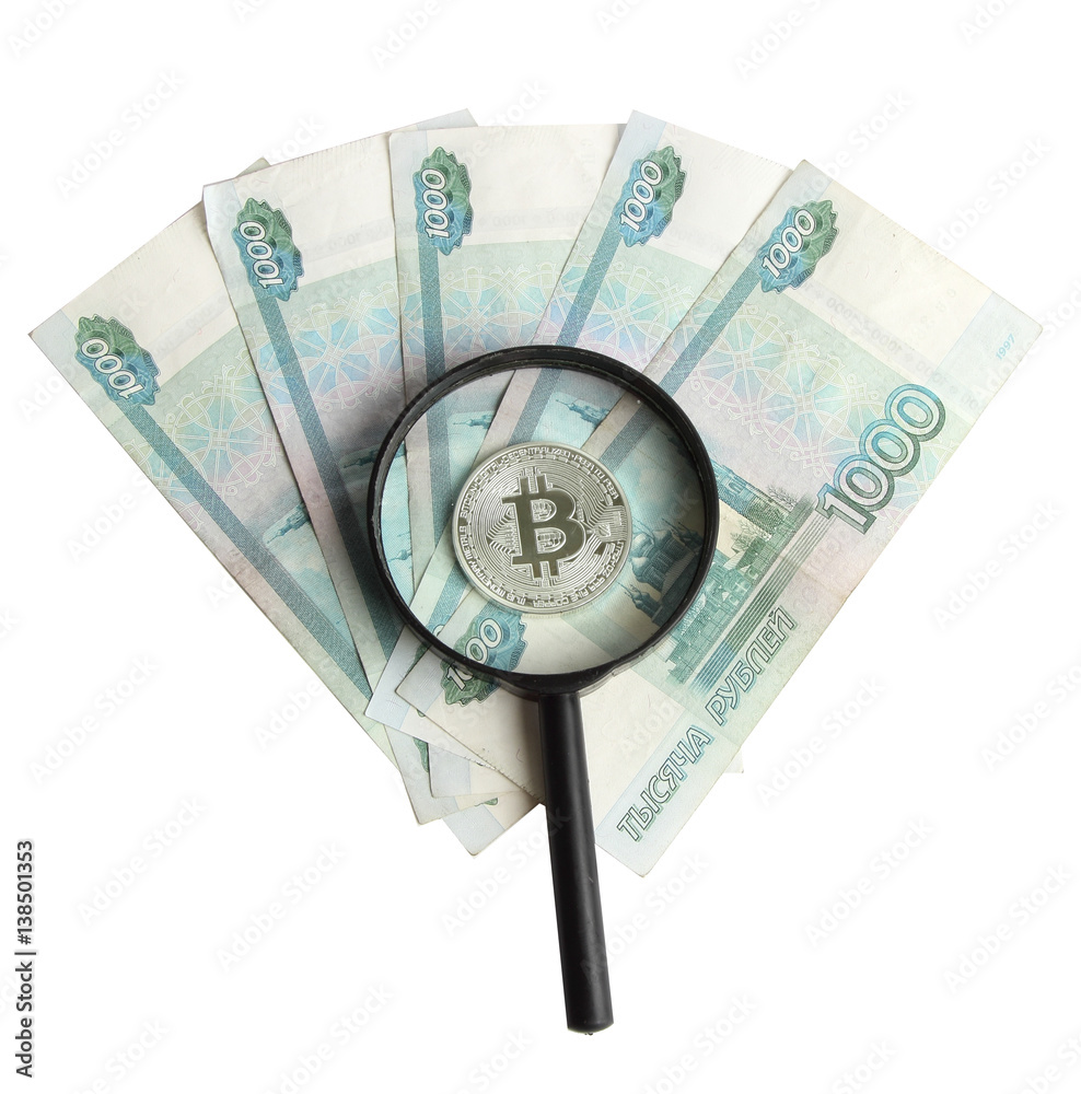 silver bitcoin on the background of Russian banknotes silver bitcoin on the background of Russian banknotes