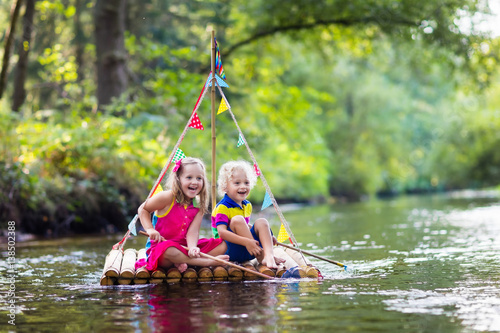 Fototapeta Naklejka Na Ścianę i Meble -  Kids on wooden raft