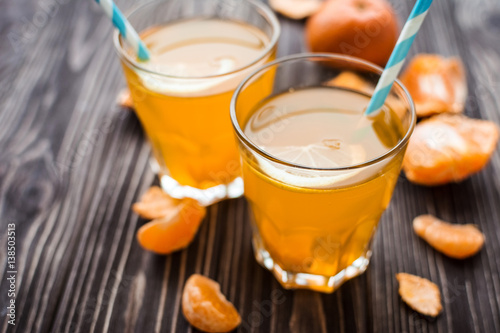Freshly squeezed tangerine juice on a wooden background