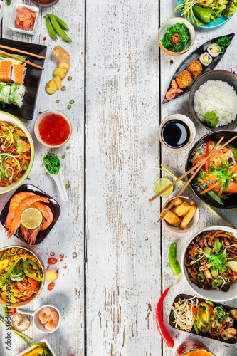 Asian food served on wooden table, top view, space for text