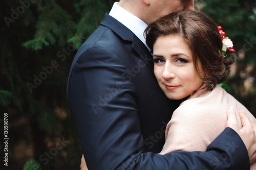 Bride and groom hugging in a forest in the autumn forest, wedding walk © nagaets