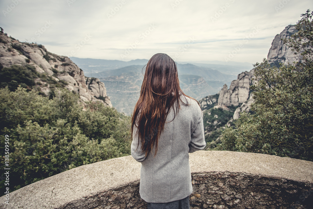 Naklejka premium Young girl in the mountains, walk on the wild