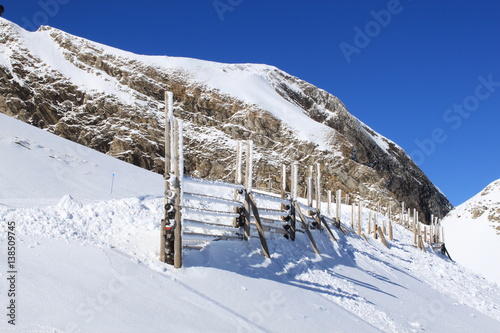 A fence cover of snow in the high of the mountains