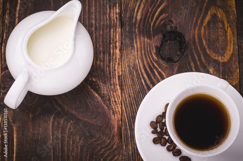 coffee background with cup and creamer on a wooden background/coffee background with cup and creamer top view