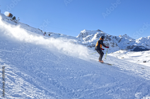 skier going down the mountain very fast in a sunny day © MonikM