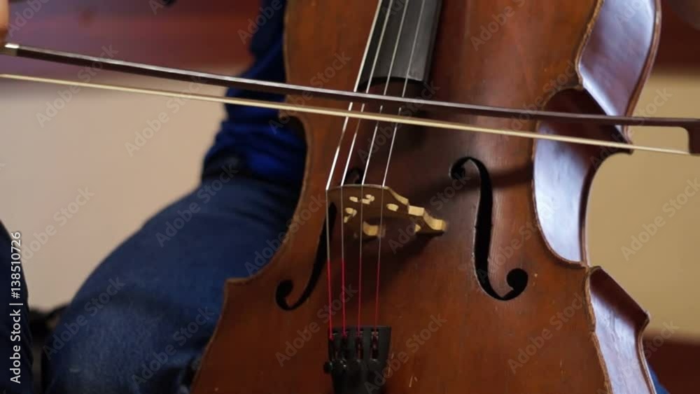 Teen violoncellist playing a cello Teen violoncellist playing a cello