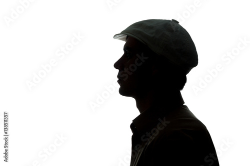 Portrait of a young man in cap, side view © alexey_m