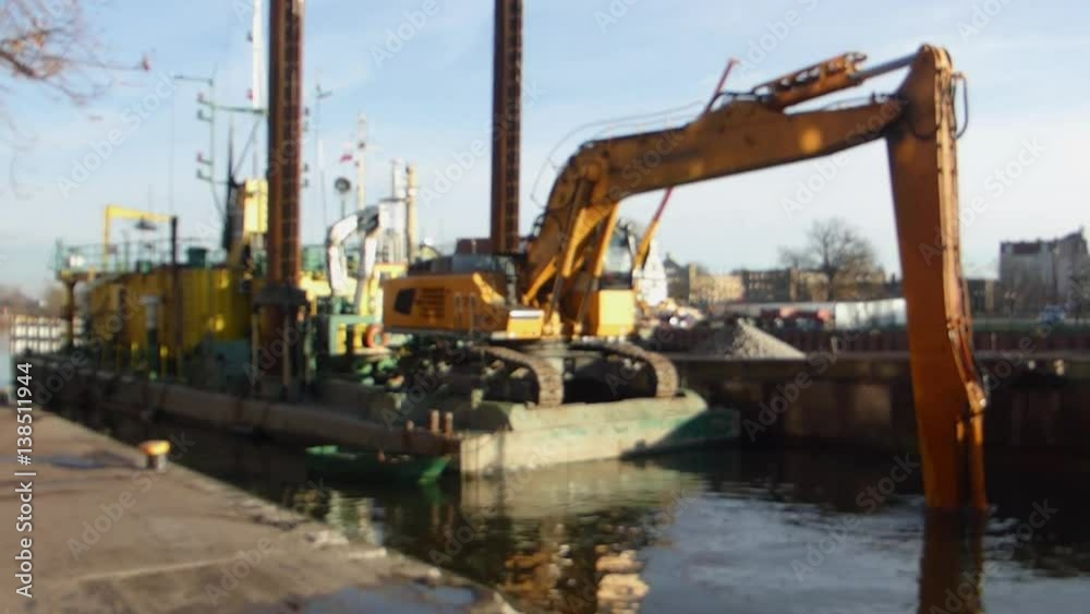 Excavator On Barge Working On River