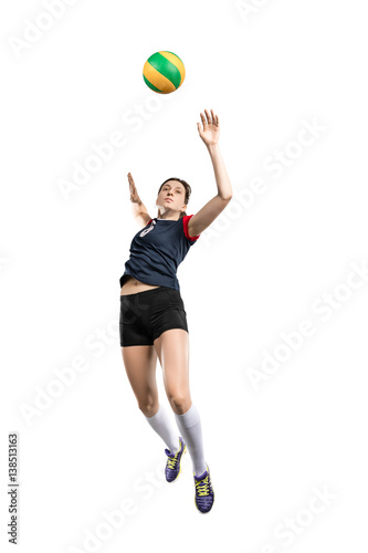 Female volleyball player hitting the ball