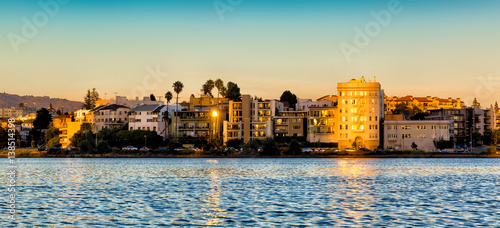Oakland, California Lake Merritt waterfront buildings at sunset