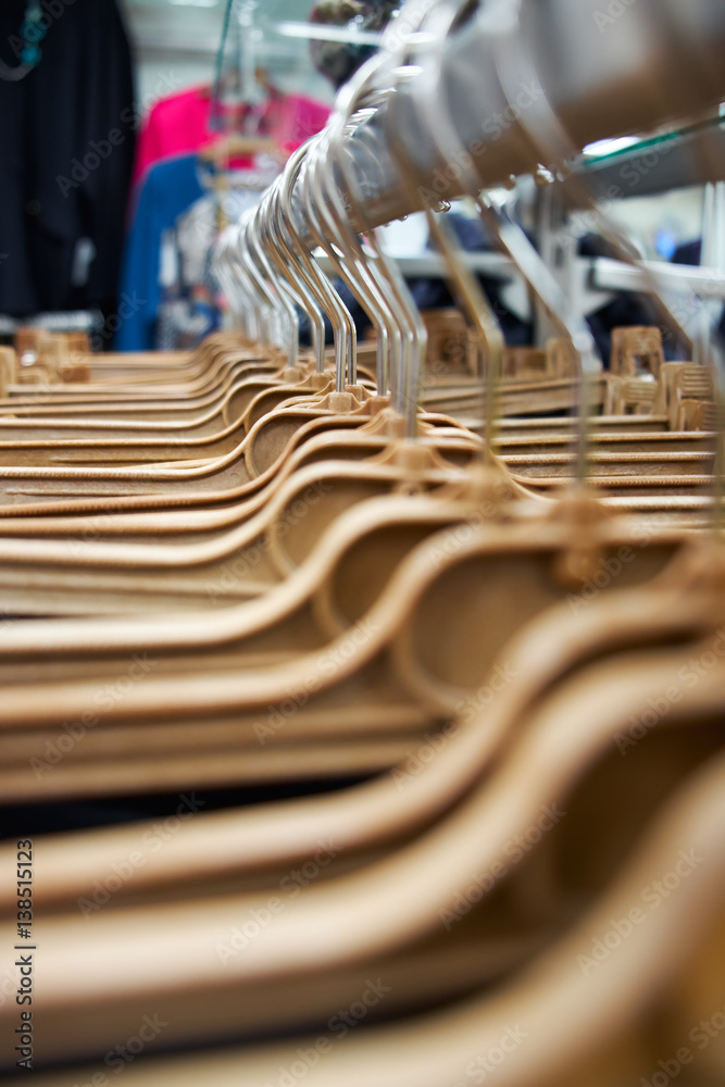 Yellow plastic hangers in a clothes shop, close-up. Yellow plastic hangers in a clothes shop, close-up.
