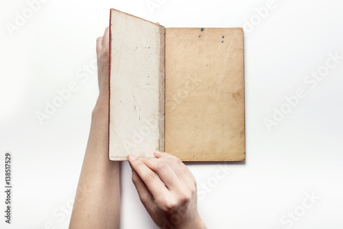 woman hand hold a vintage book isolated white. photo