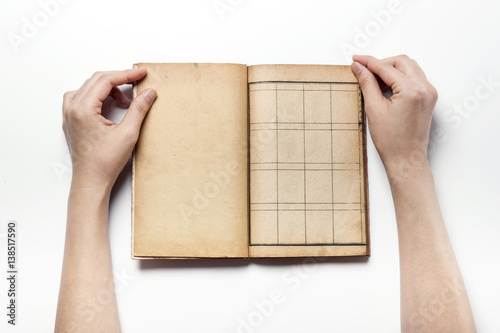 woman hand hold a vintage book isolated white. photo