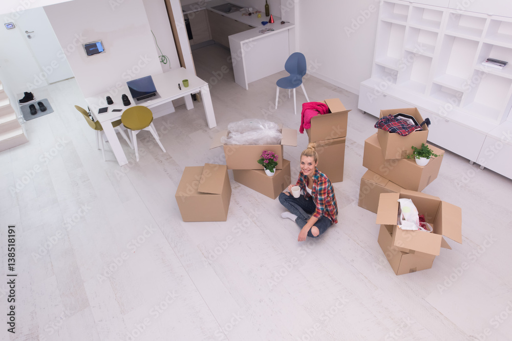 woman with many cardboard boxes sitting on floor woman with many cardboard boxes sitting on floor