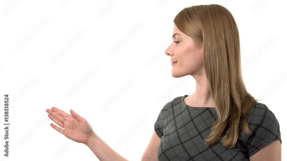 Beautiful serious businesswoman in grey dress making presentation. Isolated white background Beautiful serious businesswoman in grey dress making presentation. Isolated white background