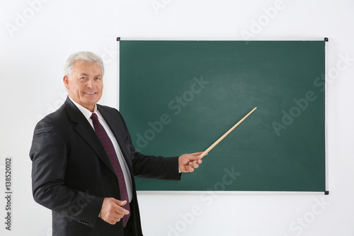 Senior teacher beside black...