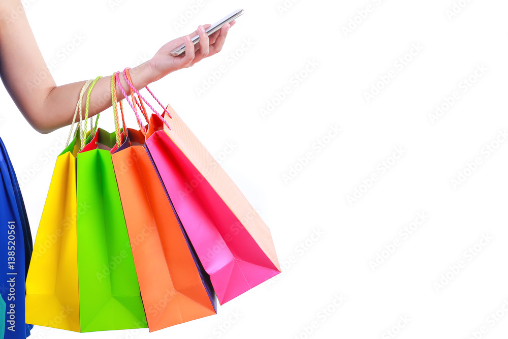 Hand holding shopping bags and mobile smart phone with blank space