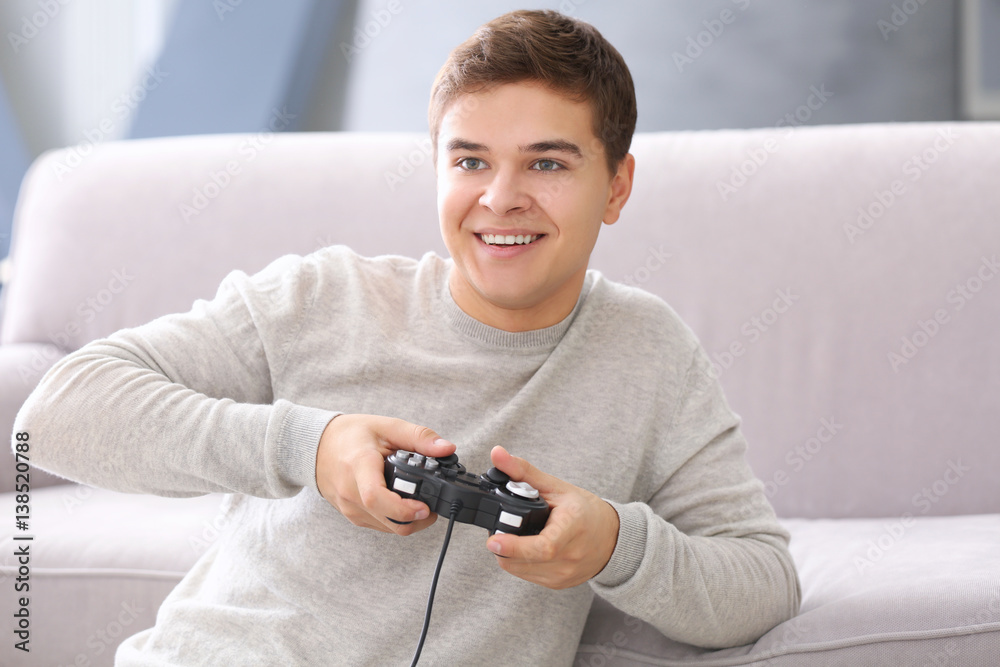 Teenager playing videogame at home Teenager playing videogame at home