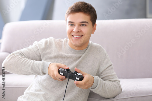 Teenager playing videogame ...