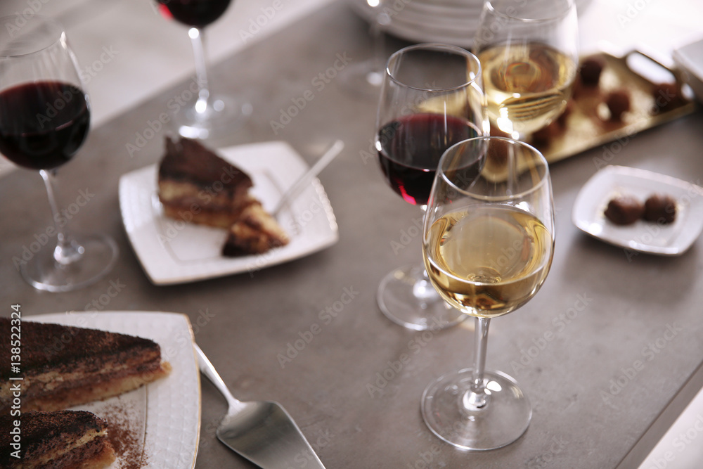 Delicious chocolate desserts and wine on grey table Delicious chocolate desserts and wine on grey table