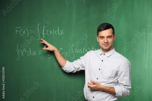 Handsome young teacher expl...