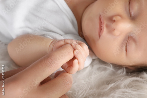 Cute little baby holding mo...