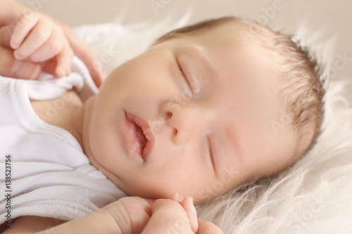 Cute sleeping baby with mother at home, closeup