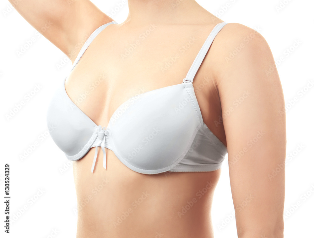 Young woman in bra on white background