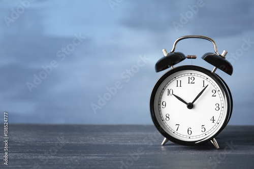 Alarm clock on wooden table