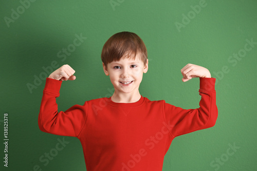 Cute little boy on color ba...