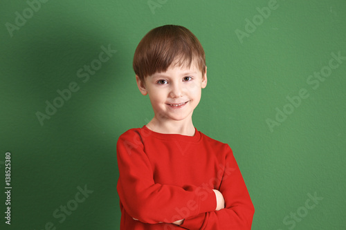 Cute little boy on color ba...