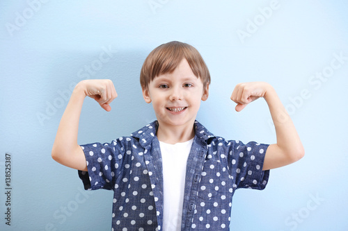 Cute little boy on light ba...
